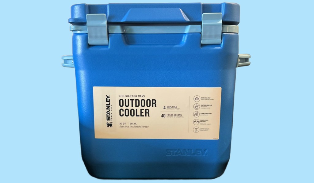 Blue Stanley outdoor cooler on light blue background