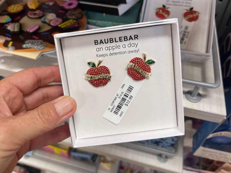 A pair of earrings shaped like apples