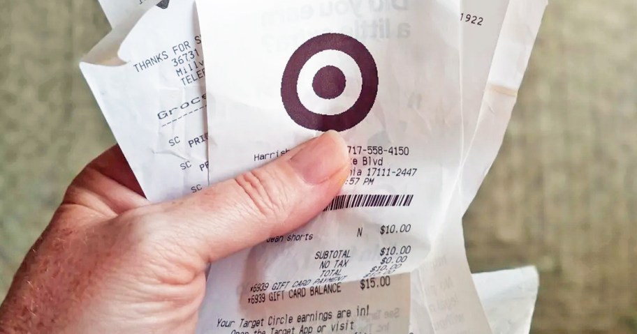 hand holding a handful of receipts