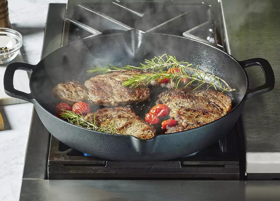 The Big One 13in Pre-Seasoned Cast-Iron Pan with Pour Spout on s tove top