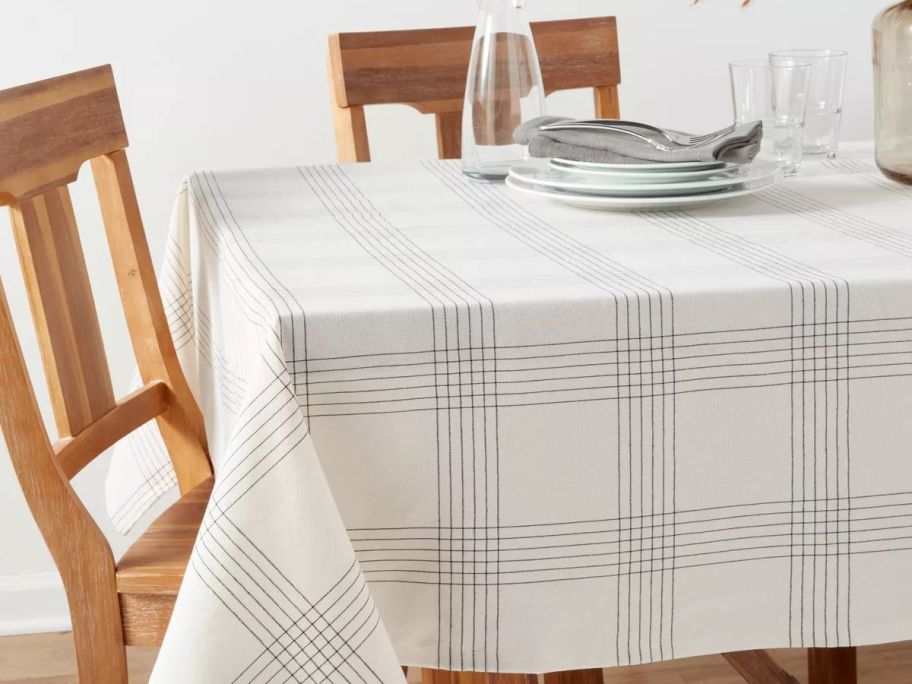 A table with a Threshold Cotton Open Plaid Tablecloth