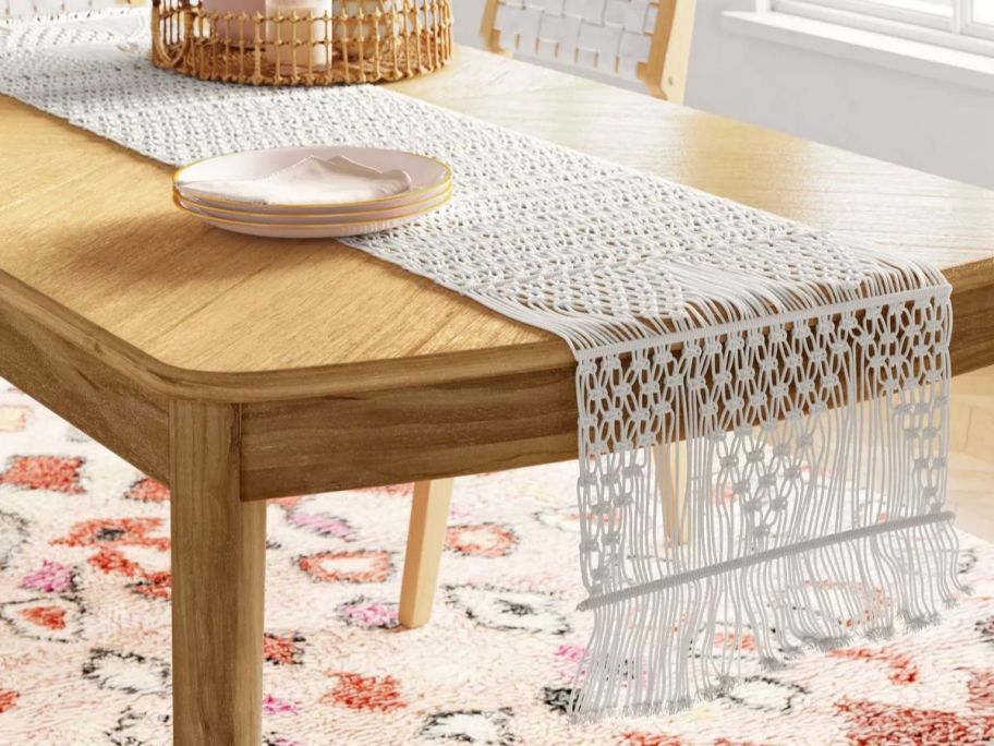 A table with a Threshold White Cotton Macrame Runner