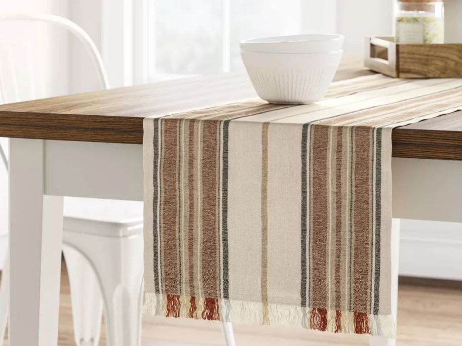A table with a Threshold Striped Table Runner on it