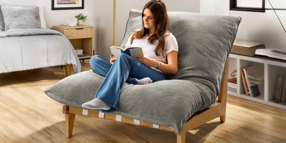 Woman reading a book while sitting on the Member's Mark Cloud Chair