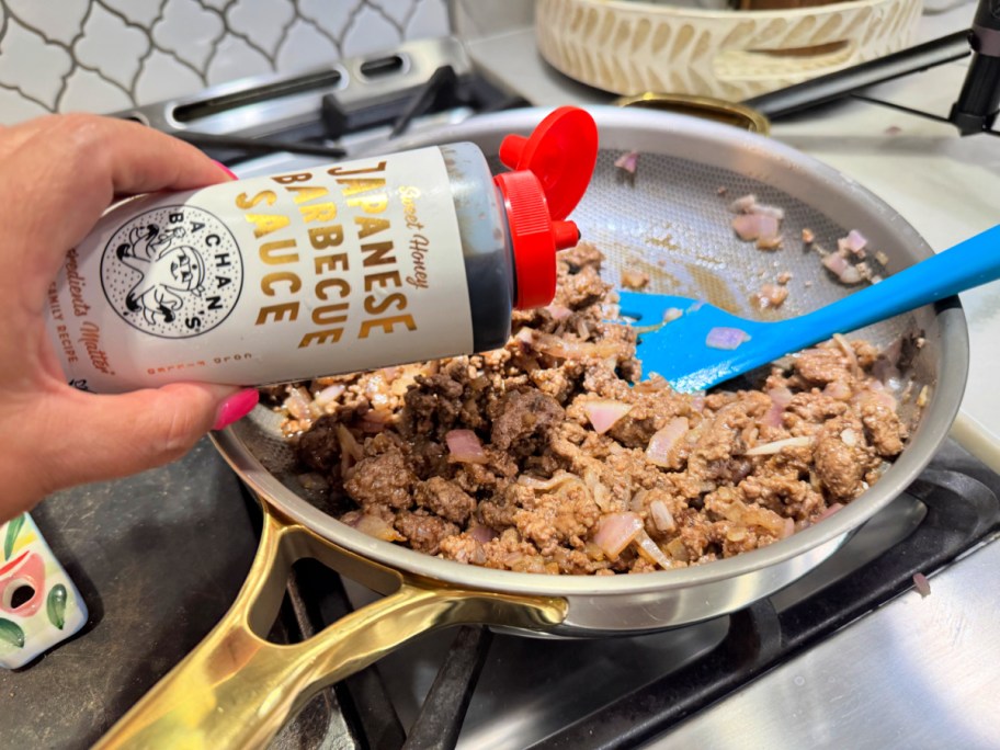 adding bachan's japanese sauce to cooked ground beef in a skillet (1)