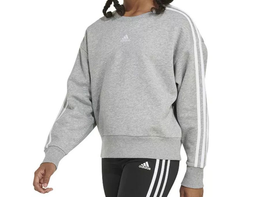 girl wearing grey adidas Girls Heather Fleece Crewneck Sweatshirt