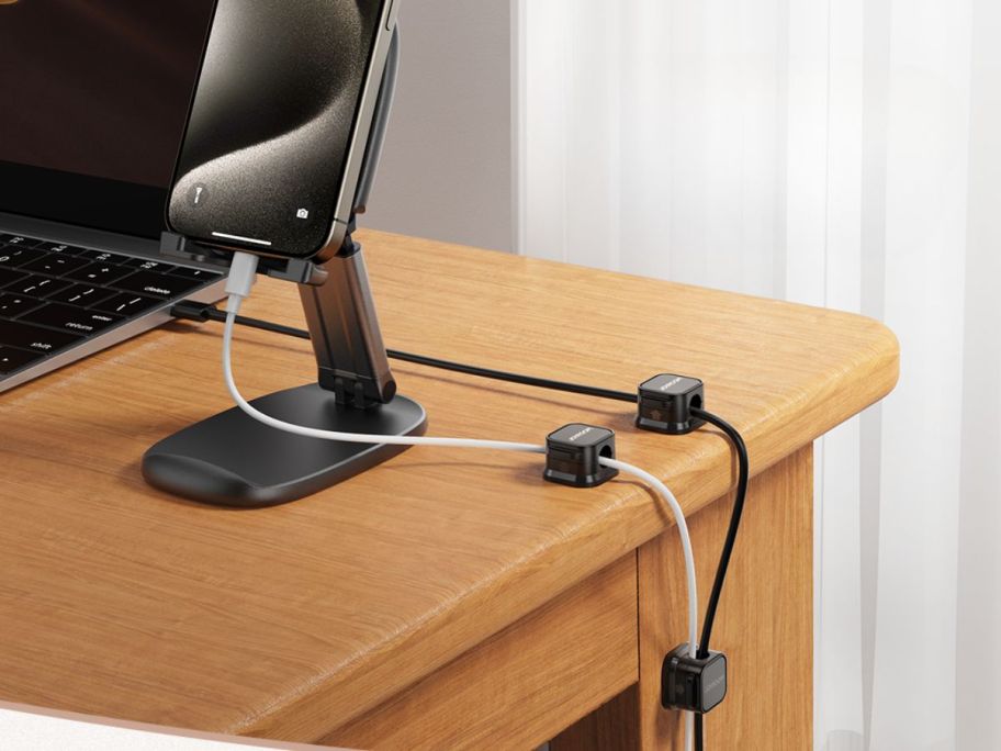 black clips holding cords on desk