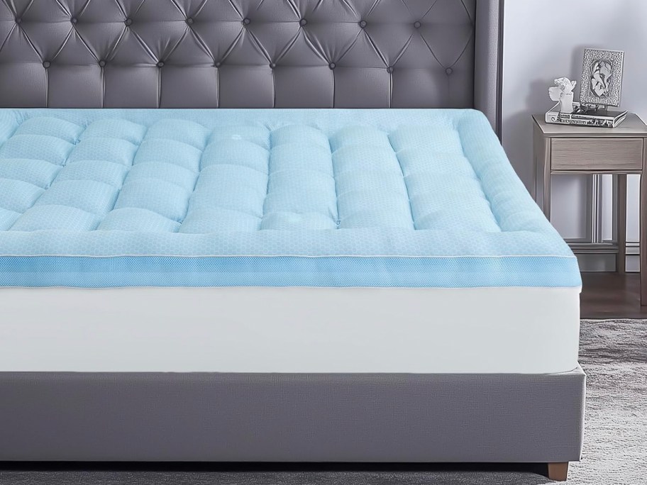 blue mattress topper on bed 