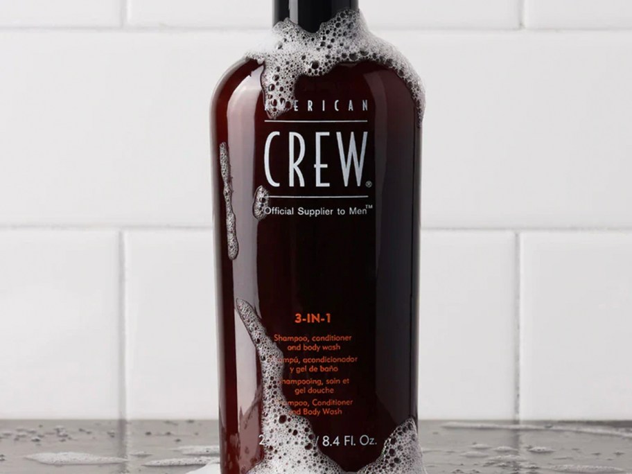 american crew bottle with soap on counter