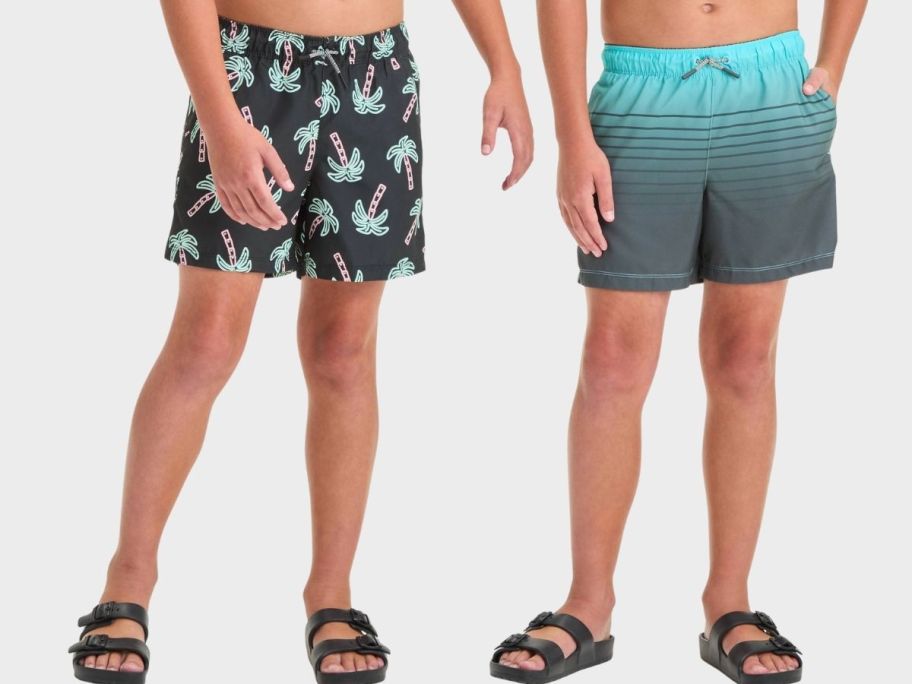 two boys in printed swim trunks