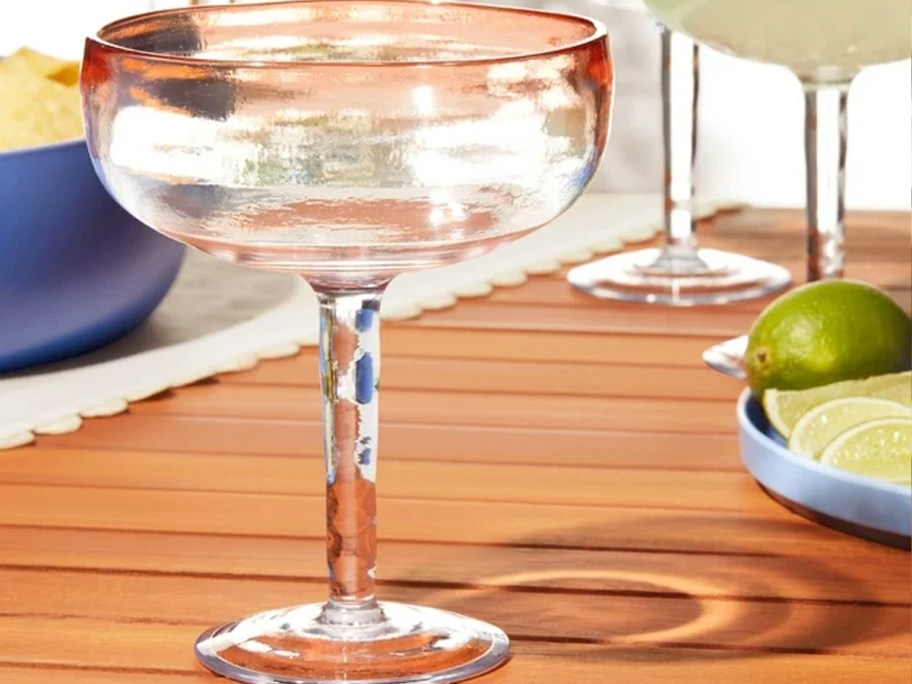 clear and orange margarita glass on table
