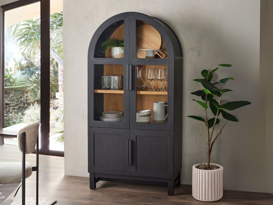 black Better Homes & Gardens Juliet Round Frame Arc Cabinet against wall in dining room