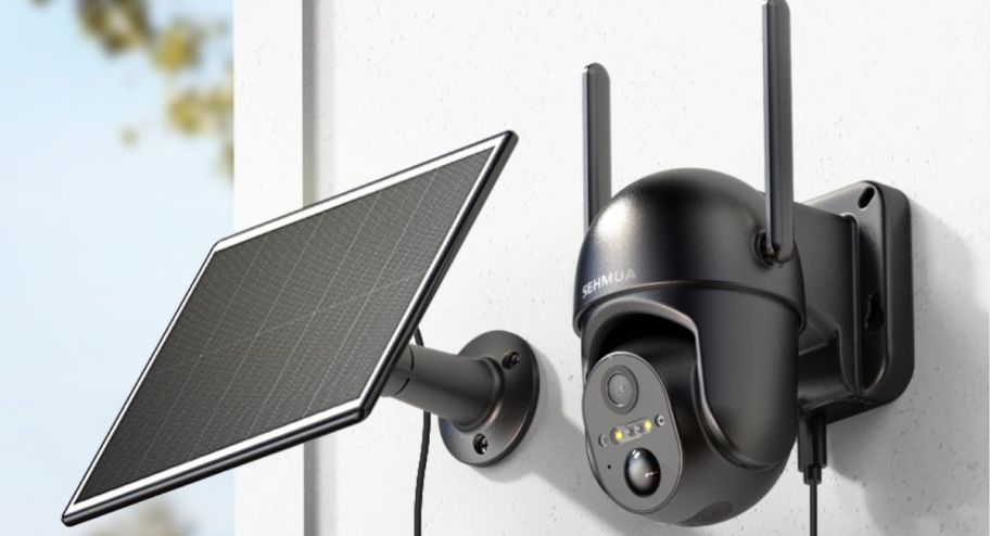 Outdoor security camera with solar panel next to it 