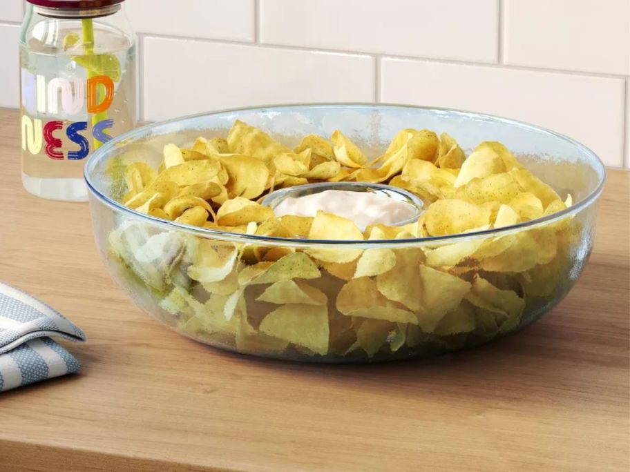 chip and dip bowl fill with chips and dip on kitchen counter