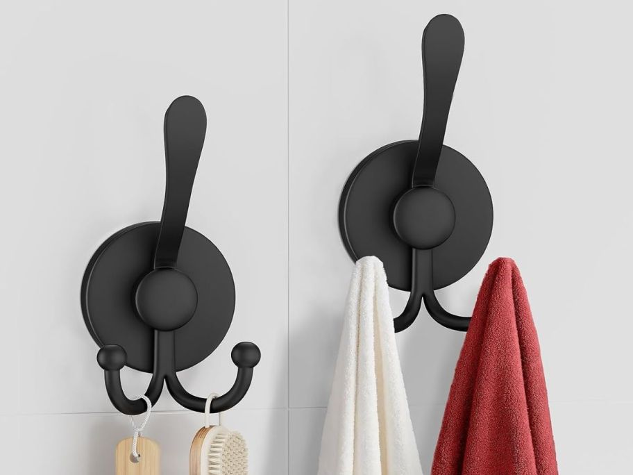 black clothing hook with towels and bathroom essentials 