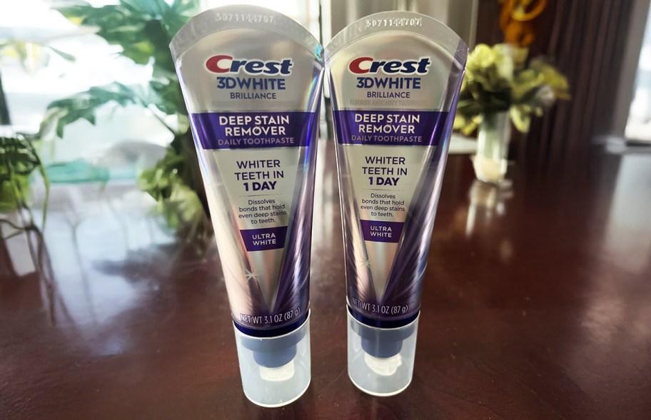 two tubes of Crest 3d deep stain remover toothpaste on a table