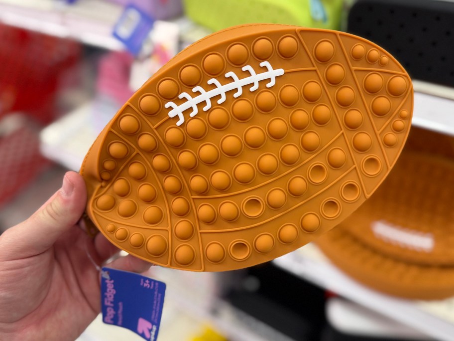 hand holding football pencil case