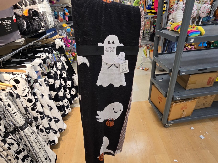 hand holding black and white ghost blanket 