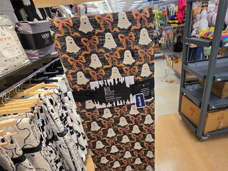 hand holding orange and black ghost blanket