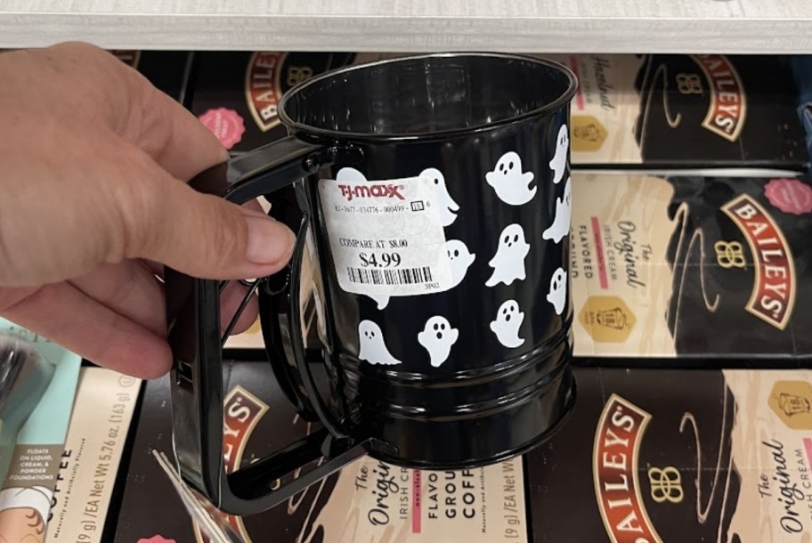 a womans hand holding a ghost themed flour shifter
