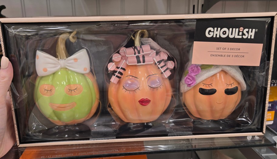 three ceramic pumpkins in box on shelf
