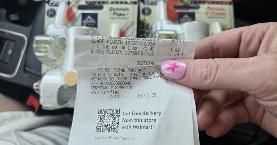 a womans hand holding a walmart receipt