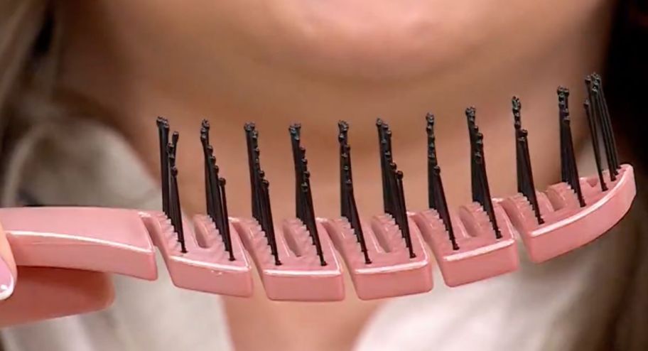 Person holding up hair brush showing the bristles
