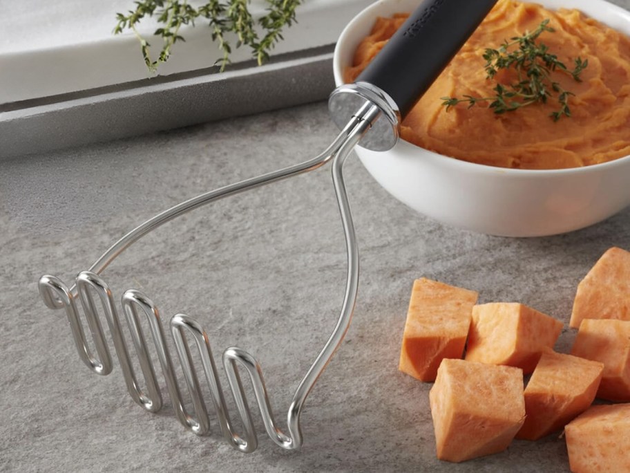 a KitchenAid wire masher on a counter