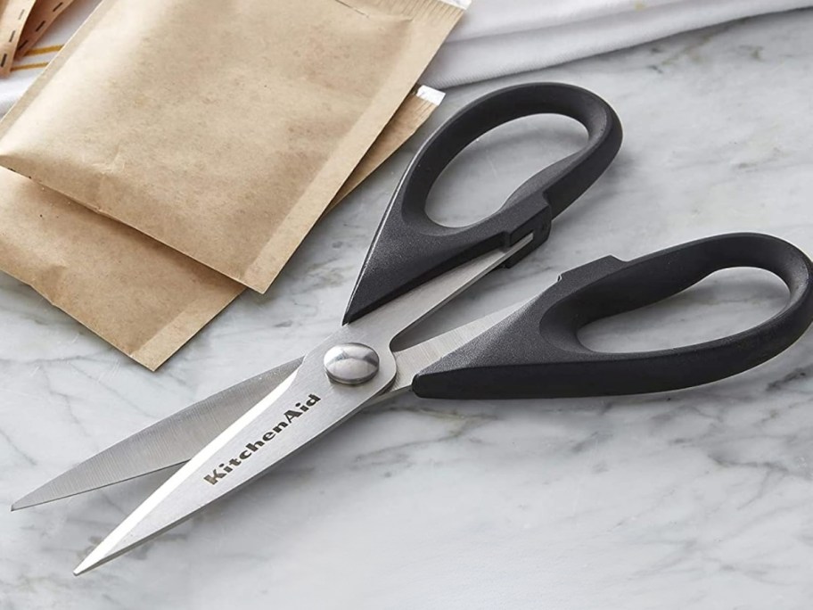 a pair of kitchne scissors woth black handles