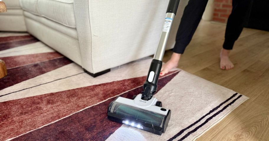 person using Levoit Cordless Vacuum Cleaner on rug