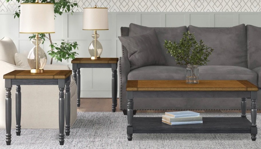 blue and brown coffee and side tables in front of gray couch 