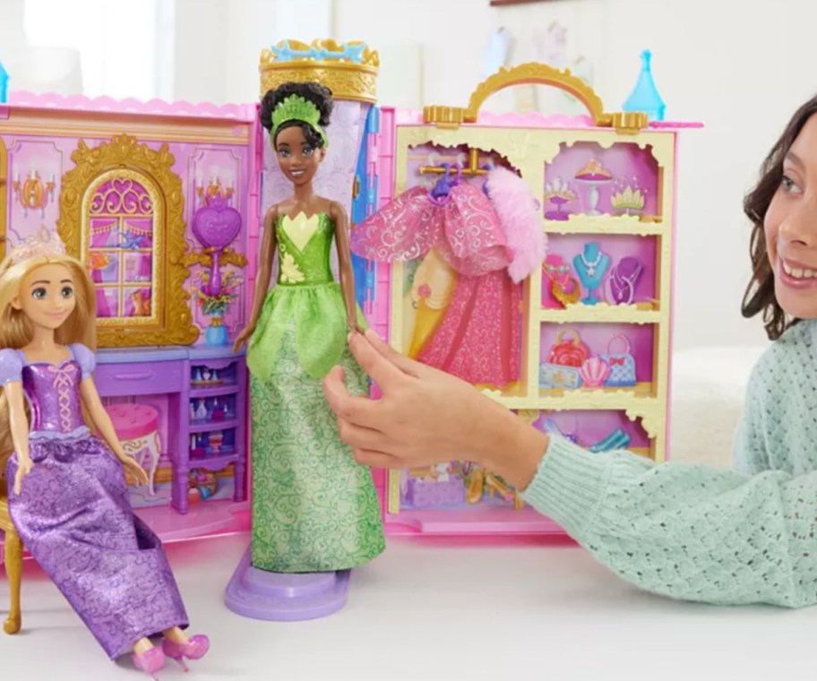 girl playing with princess dolls