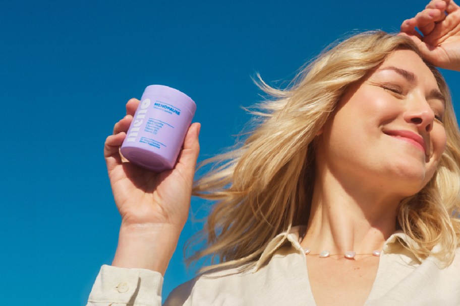 woman holding menopause supplement 