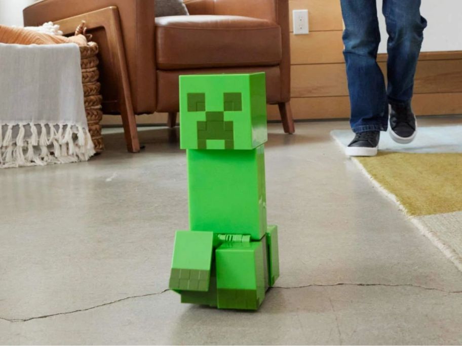 kid controlling Minecraft Exploding RC Creeper on floor