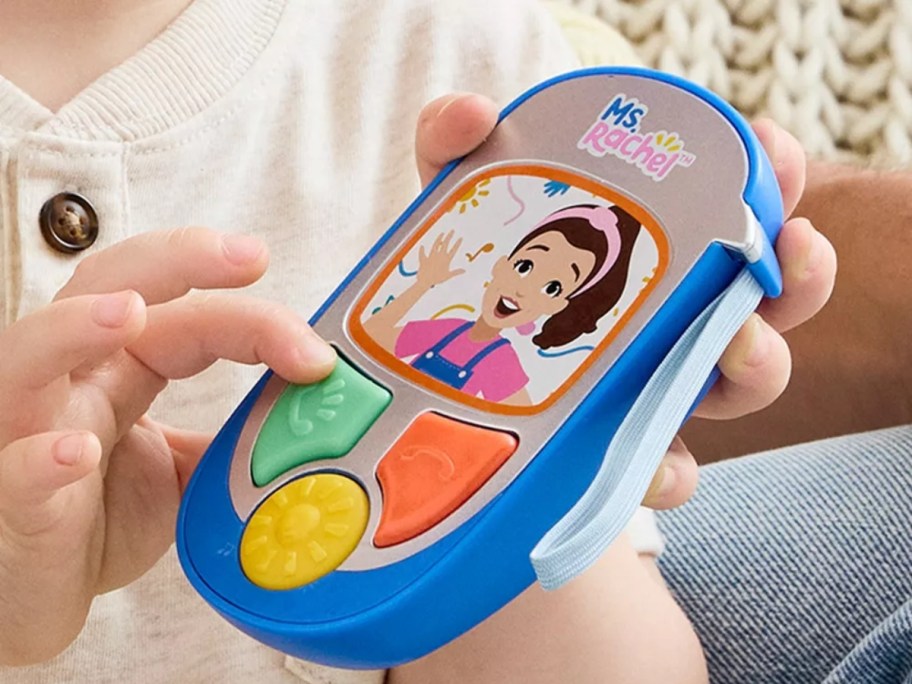 kid playing with a Ms. Rachel learning phone toy