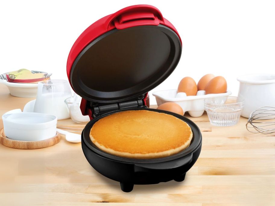 red MyMini Pancake Griddle on counter with pancake in it