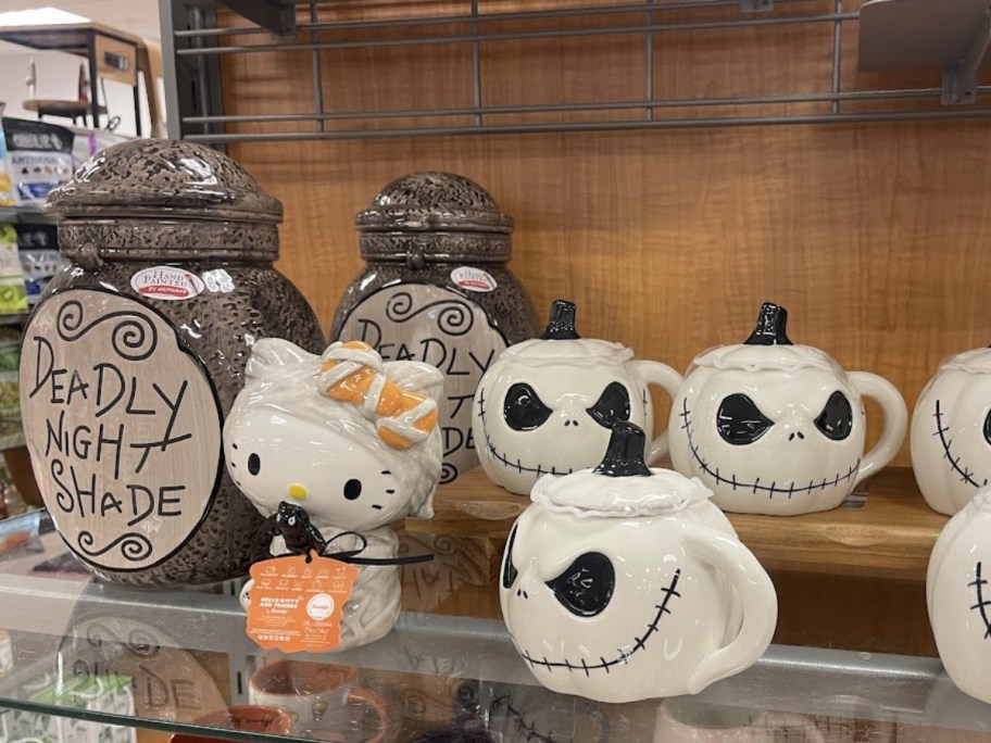 nightmare before christams and hellow kitty drinkware on a store shelf