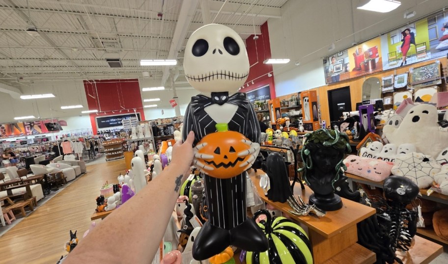 womans hand holding a halloween figure