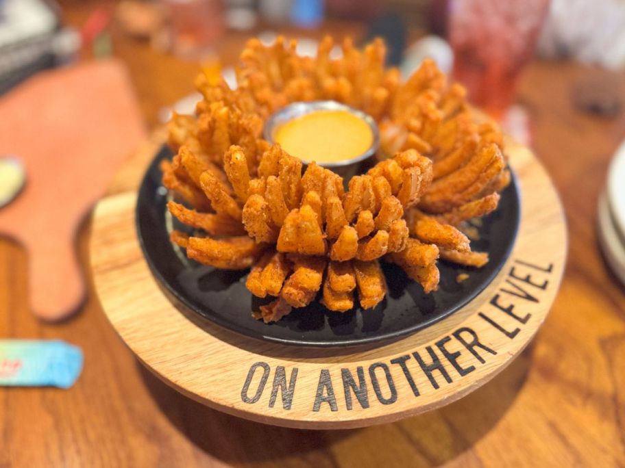 outback onion displayed on top of the table with sauce in the middle