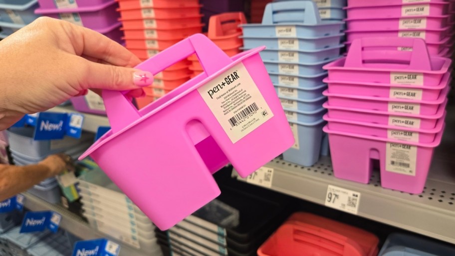 a womans hand holding a plastic caddy