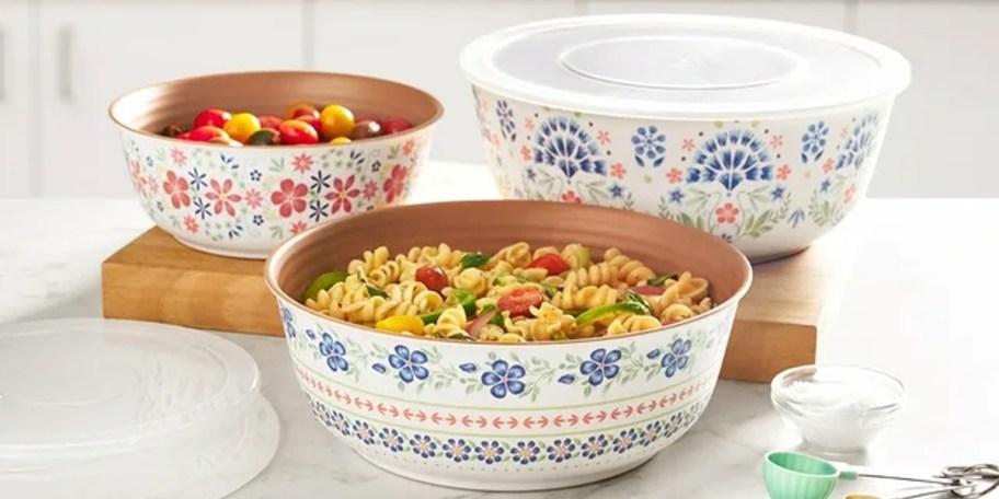 white floral bowl sets full of rice and lids on table