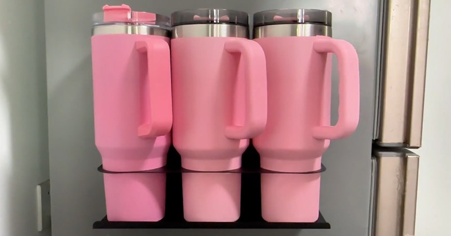 three pink tumblers on a magnetic organizer