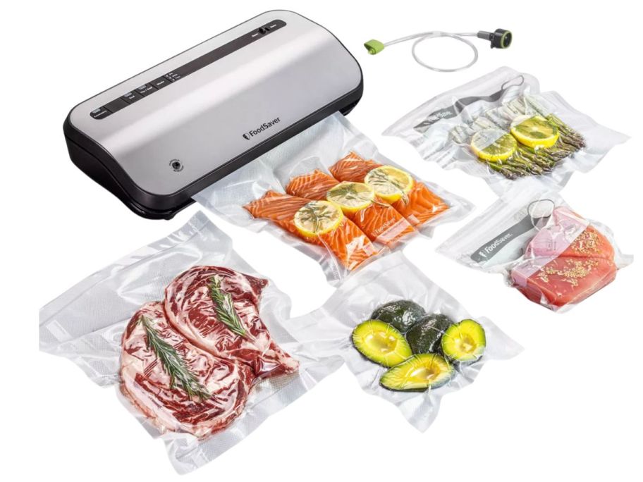FoodSaver Preserve Vacuum Sealer with bags filled with food in front of it