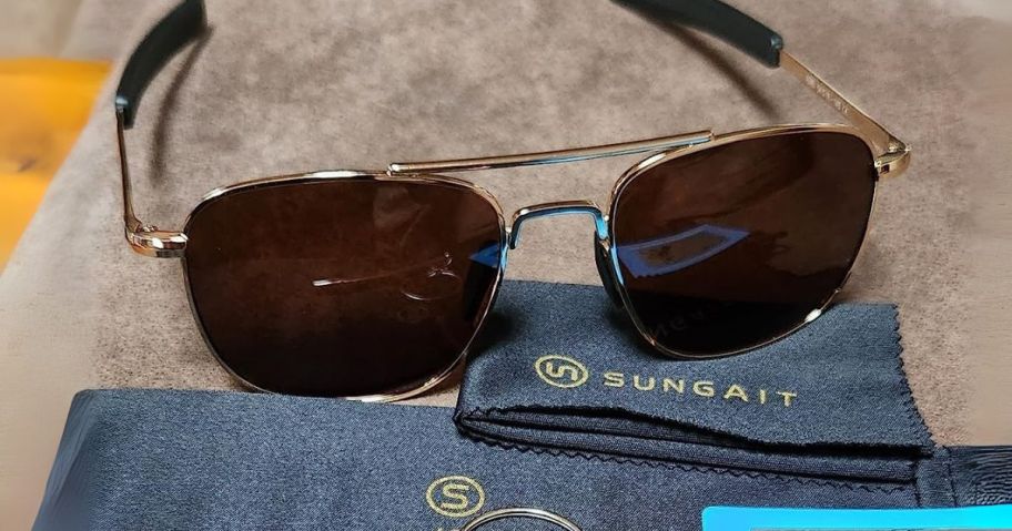 men's aviator sunglasses on counter with sungait packaging