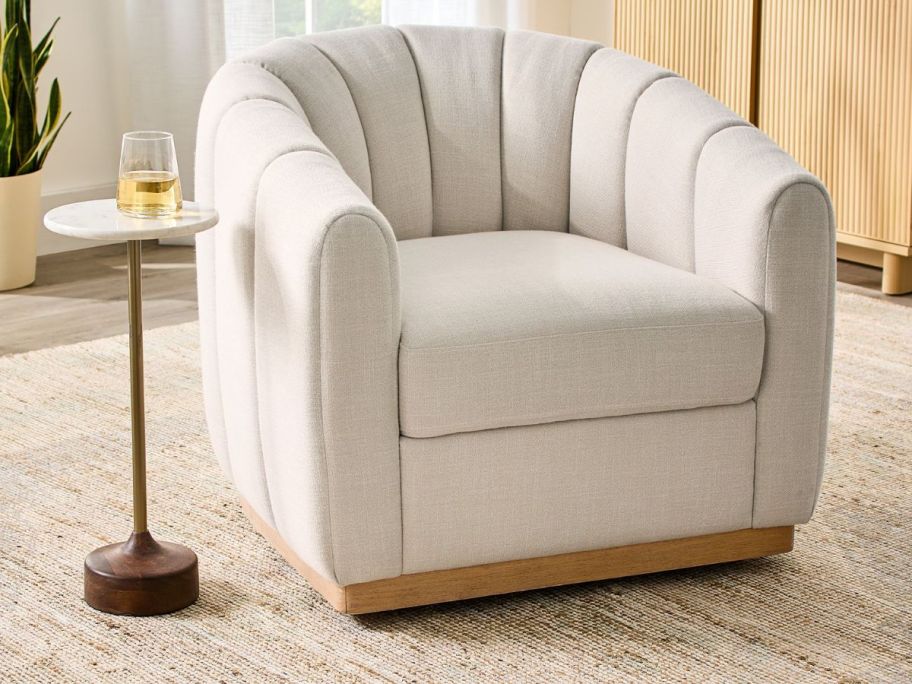 cream colored Better Homes & Gardens Lillian Accent Swivel Chair in living room
