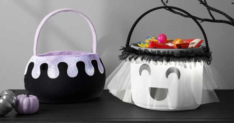 fabric cauldron and ghost trick or treat baskets on a table with Halloween decor