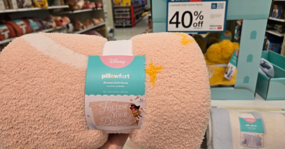 a Disney Princess throw blanket with more items behind it at Target
