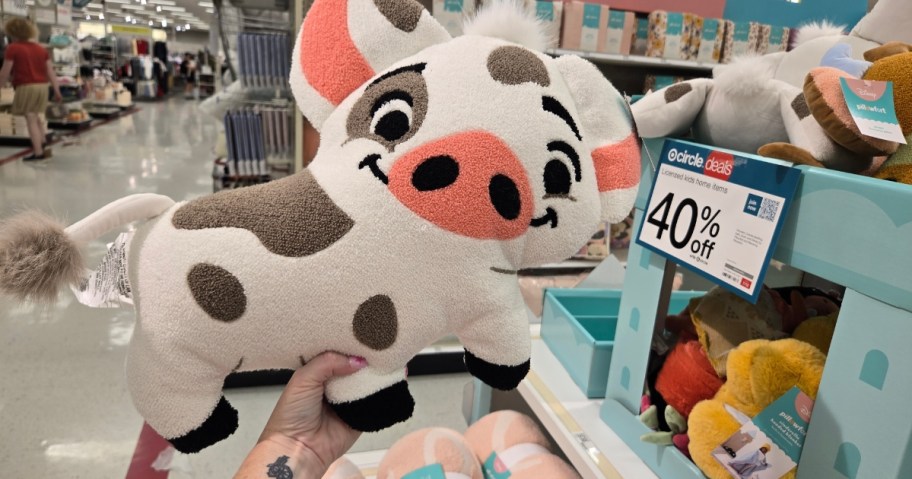 hand holding a Pua the Pig from Moana Throw Pillow at Target