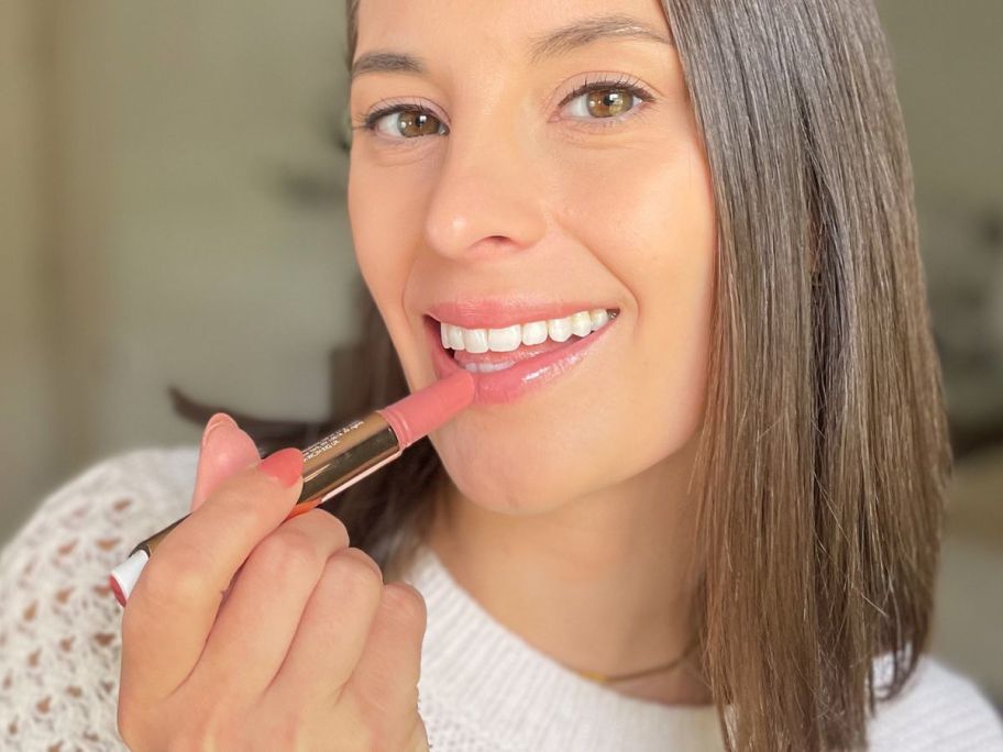 Woman applying a tarte maracuja Juicy Lip Gloss to her lips