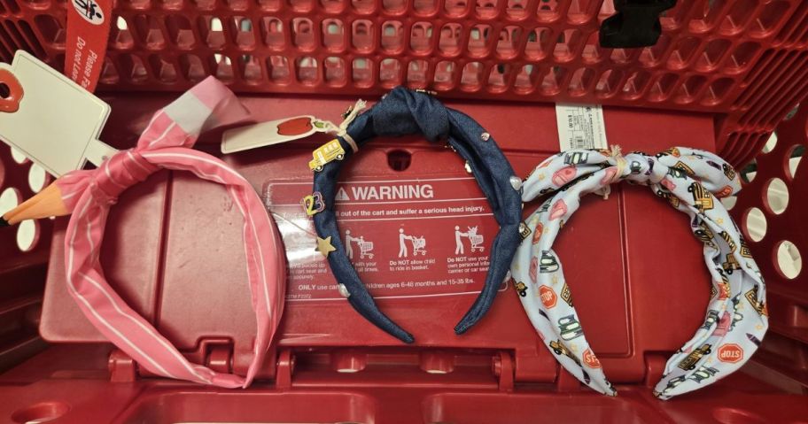three teacher headbands in cart in store in pink, blue, and a printed white design